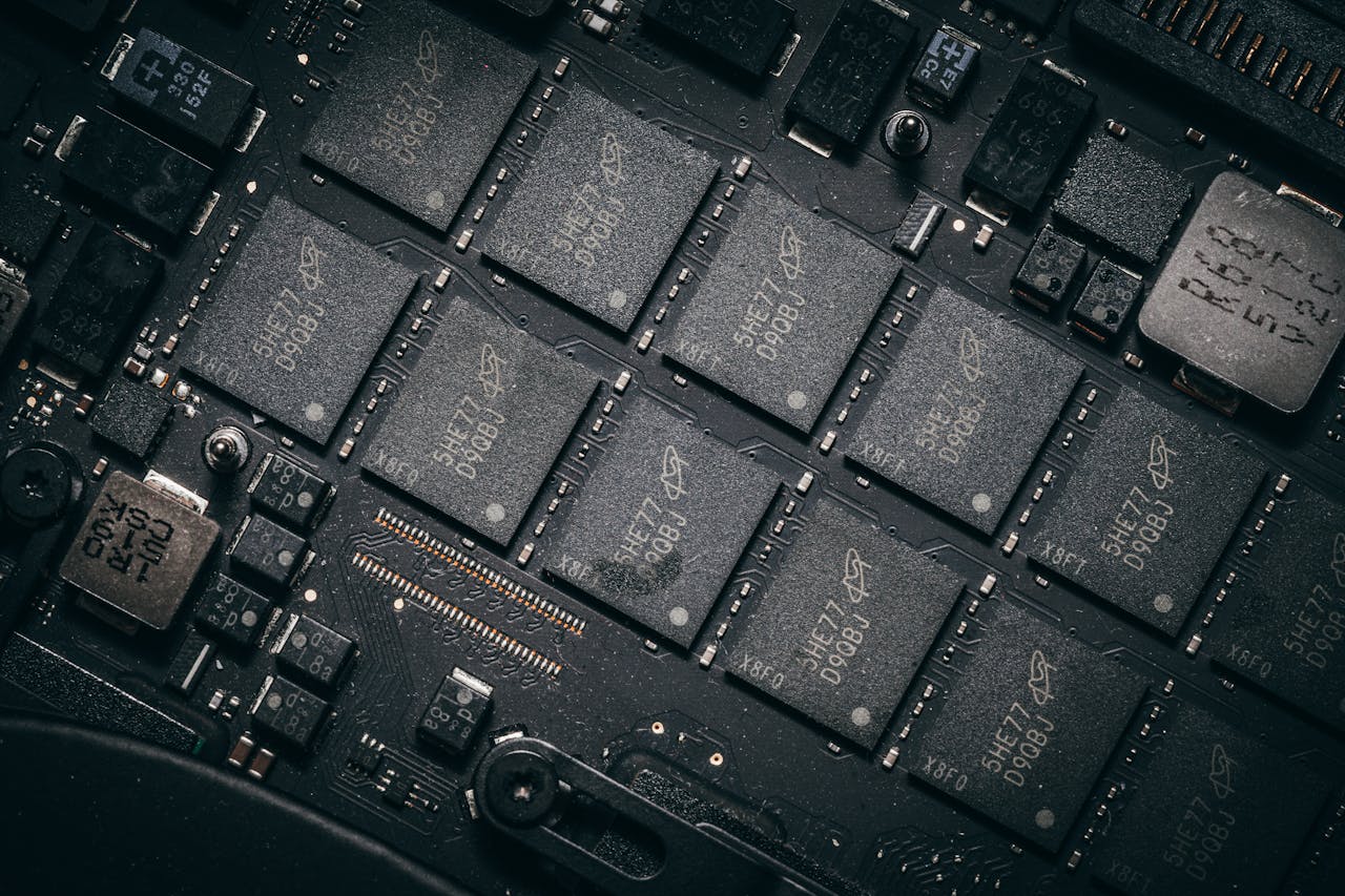 Detailed view of electronic circuit board components showcasing microchips and technology intricacies.
